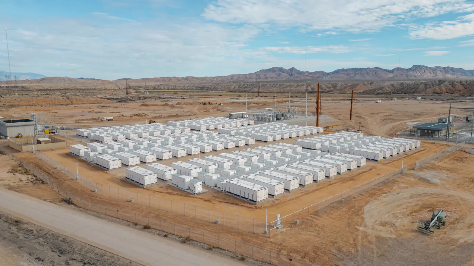 Rows of containerised battery energy storage units at a grid-scale site
