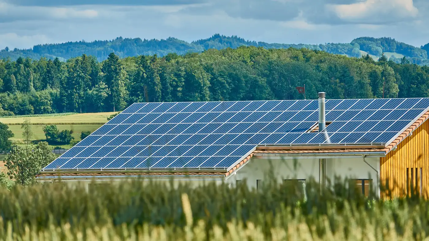 A rural property with a large solar array covering its roof